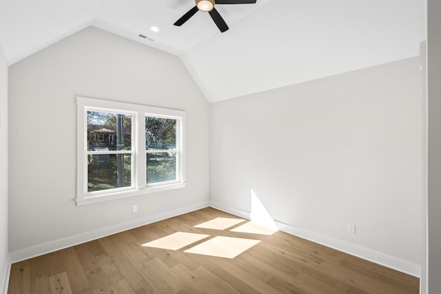 unfurnished room with hardwood / wood-style floors, vaulted ceiling, and ceiling fan