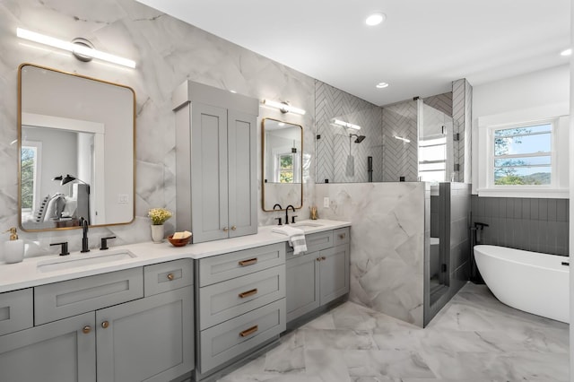 bathroom with plus walk in shower, vanity, and tile walls