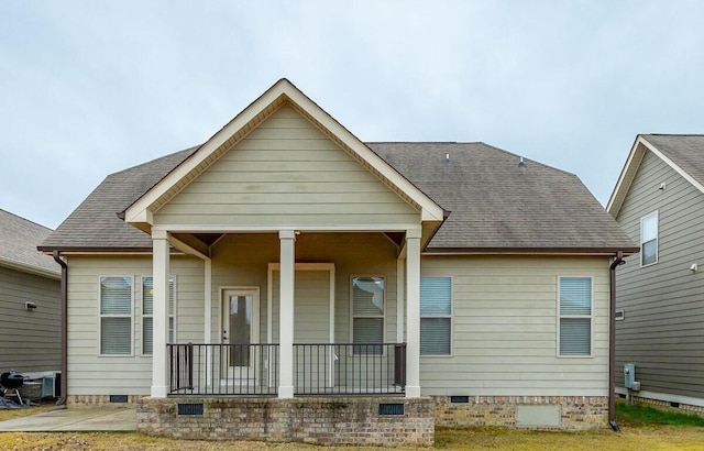 back of property featuring covered porch