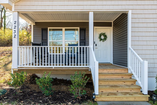 view of exterior entry featuring a porch