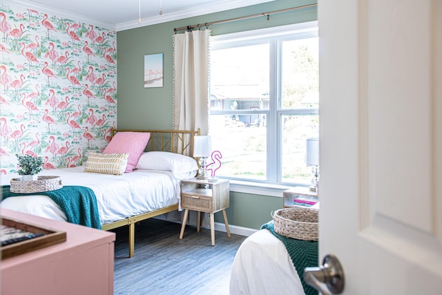 bedroom featuring crown molding and hardwood / wood-style flooring