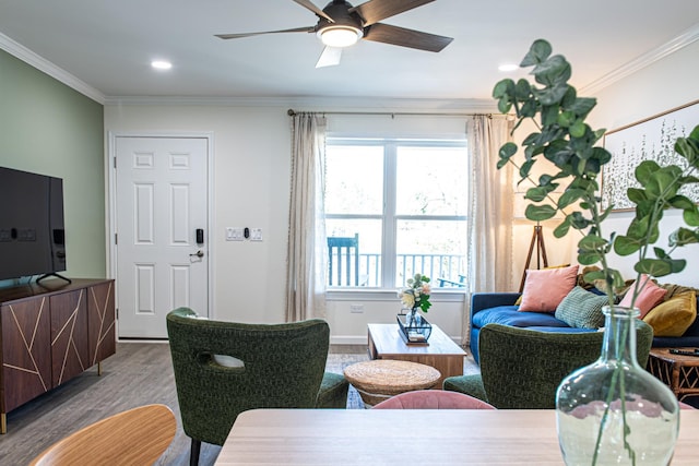 living room featuring hardwood / wood-style flooring, crown molding, and ceiling fan