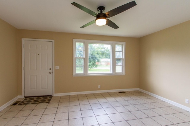 entryway featuring light tile patterned floors and ceiling fan