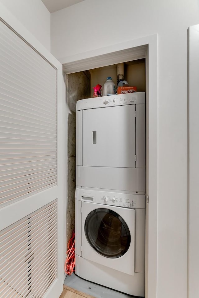 laundry room with stacked washer / dryer