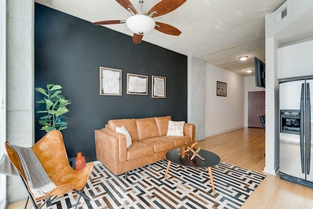 living room with ceiling fan and light hardwood / wood-style floors