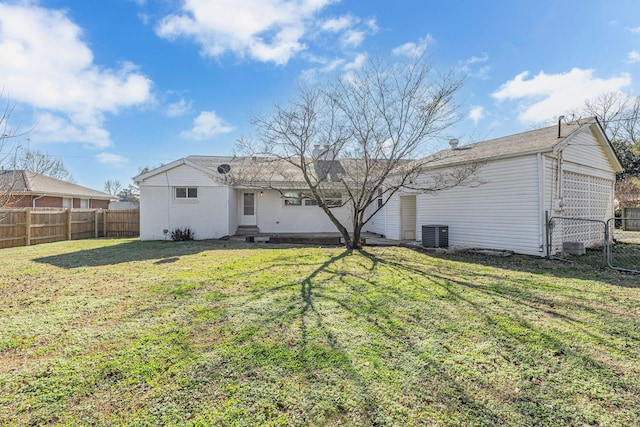 back of property featuring a lawn and central AC unit