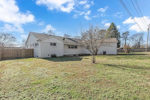 rear view of house with a yard