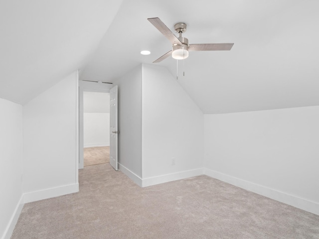 additional living space featuring ceiling fan, light carpet, and vaulted ceiling