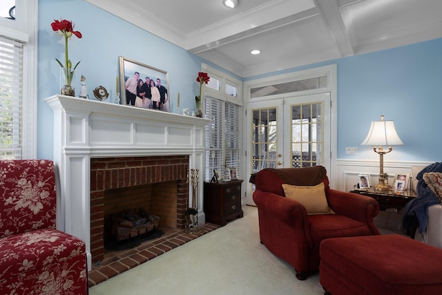 carpeted living room featuring coffered ceiling, french doors, crown molding, a fireplace, and beam ceiling