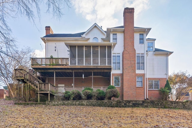 back of property with a sunroom and a wooden deck