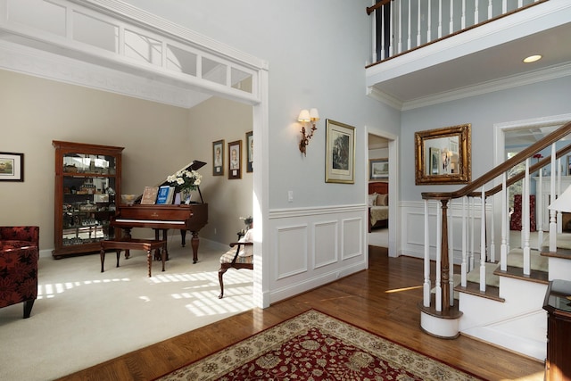 entryway with hardwood / wood-style floors and ornamental molding