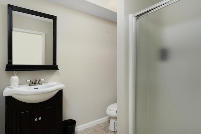 bathroom with tile patterned floors, vanity, an enclosed shower, and toilet