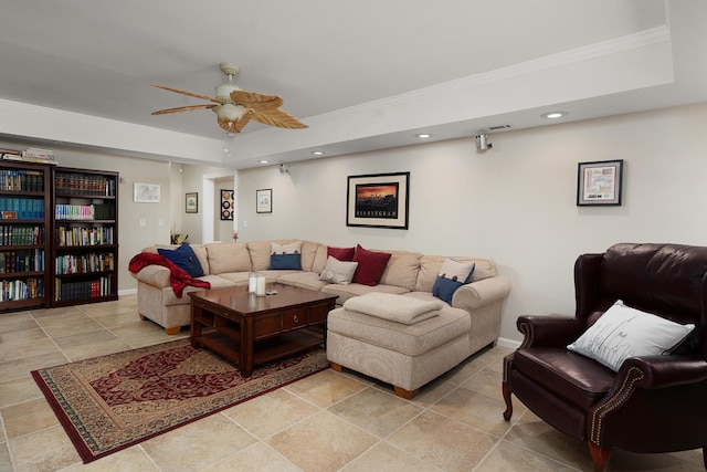 living room featuring a raised ceiling, crown molding, and ceiling fan