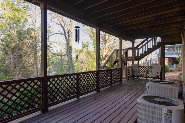 wooden deck featuring central AC unit