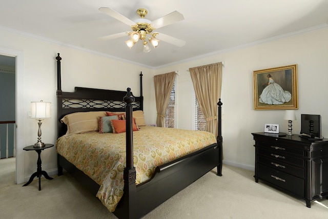 bedroom featuring ceiling fan, crown molding, and light colored carpet