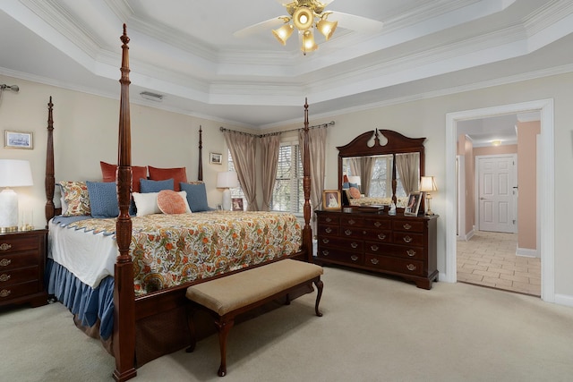 bedroom featuring ceiling fan, a raised ceiling, and crown molding