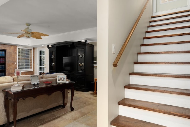 staircase with ceiling fan and ornamental molding