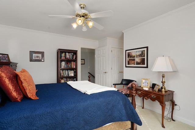 bedroom featuring light carpet, a closet, ceiling fan, and crown molding