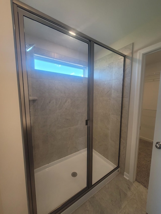 bathroom with tile patterned floors and walk in shower