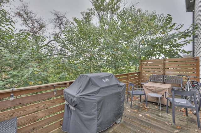 wooden deck featuring area for grilling