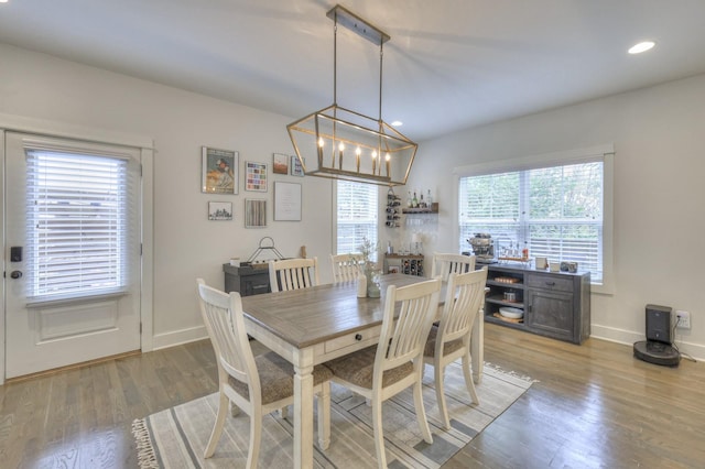 dining room featuring hardwood / wood-style floors, a wealth of natural light, and a notable chandelier