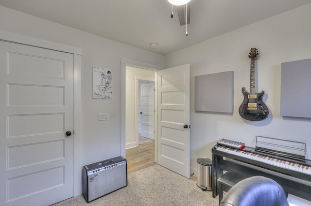 misc room with ceiling fan and light colored carpet