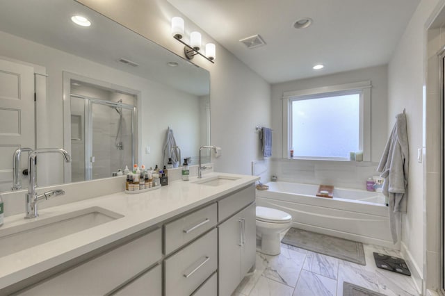 full bathroom with vanity, shower with separate bathtub, and toilet