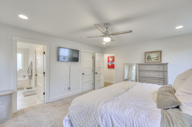 carpeted bedroom featuring ceiling fan and connected bathroom