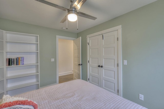 bedroom featuring ceiling fan and a closet