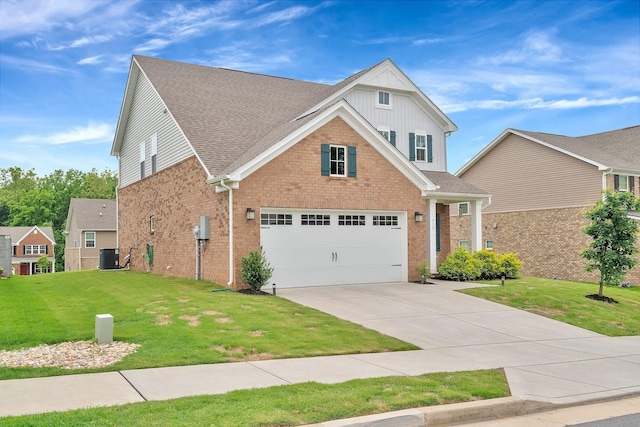 view of front of home featuring cooling unit, a front yard, and a garage