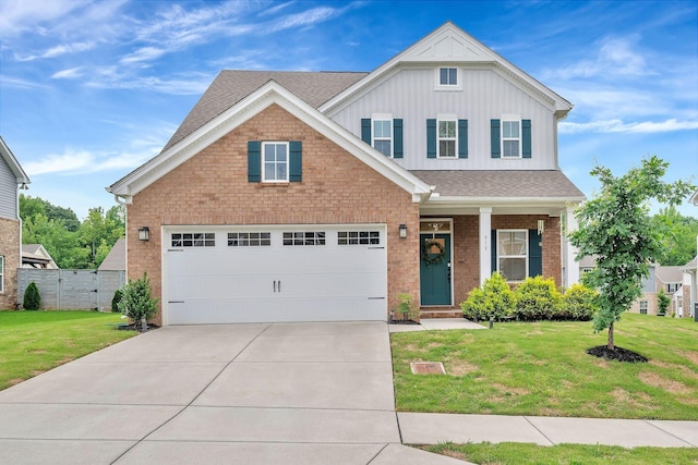 view of front of property with a front yard and a garage