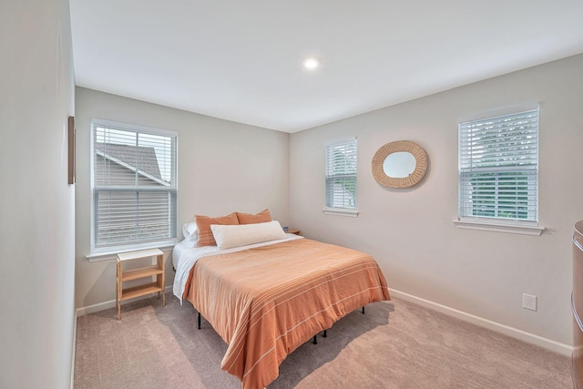 carpeted bedroom featuring multiple windows