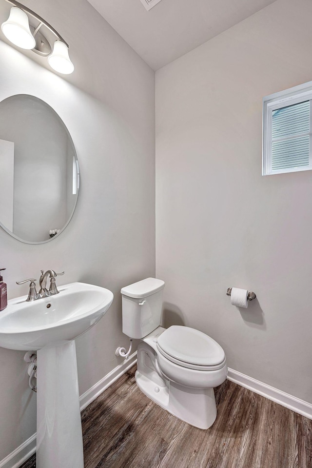 bathroom featuring hardwood / wood-style flooring, sink, and toilet