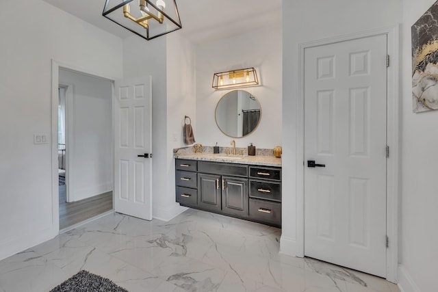 bathroom featuring a notable chandelier and vanity