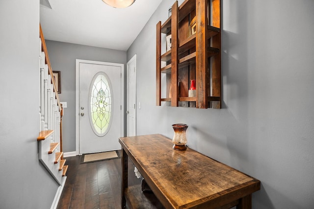 entryway with dark hardwood / wood-style flooring