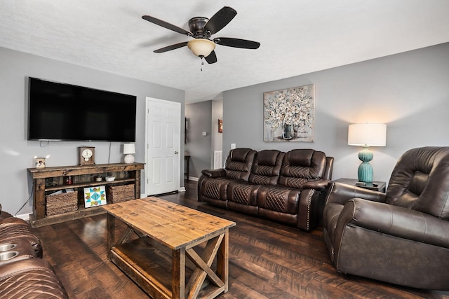 living room featuring ceiling fan and dark hardwood / wood-style floors