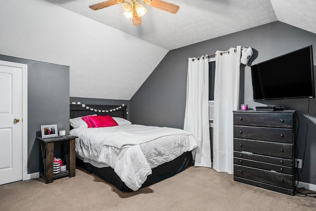 carpeted bedroom with a textured ceiling, ceiling fan, and vaulted ceiling