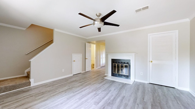 unfurnished living room featuring light hardwood / wood-style floors, ceiling fan, and ornamental molding