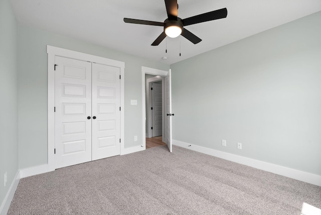 unfurnished bedroom with carpet flooring, a closet, and ceiling fan