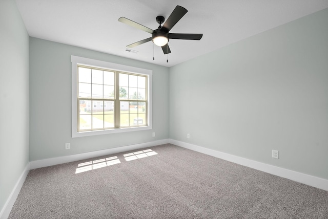 spare room featuring carpet and ceiling fan