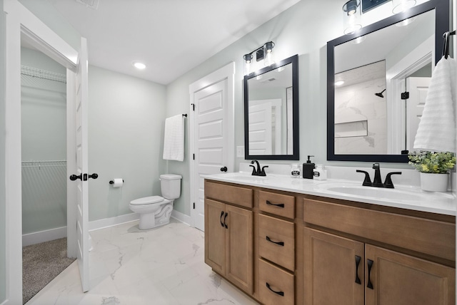 bathroom with vanity, toilet, and a shower