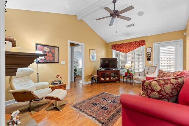 living room featuring vaulted ceiling with beams, light hardwood / wood-style floors, and ceiling fan