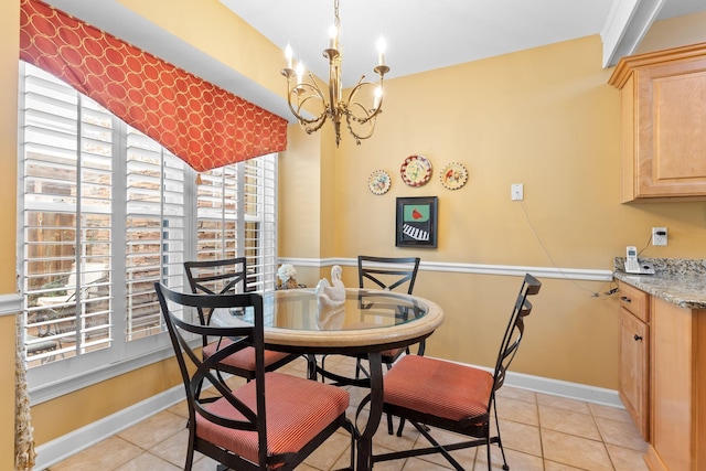 tiled dining room with a chandelier