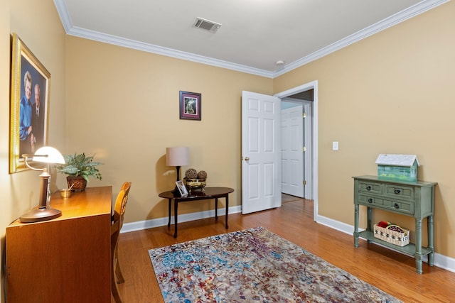 office with hardwood / wood-style flooring and crown molding