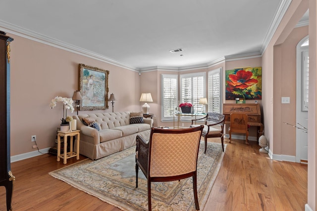 living room with light hardwood / wood-style floors and ornamental molding