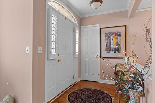 foyer entrance featuring hardwood / wood-style flooring and crown molding