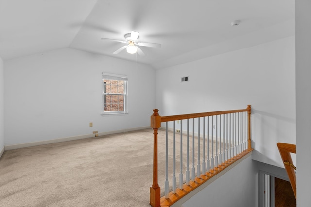 additional living space featuring ceiling fan, light colored carpet, and vaulted ceiling