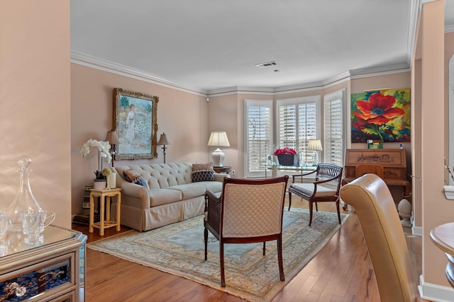 living room with ornamental molding and hardwood / wood-style flooring