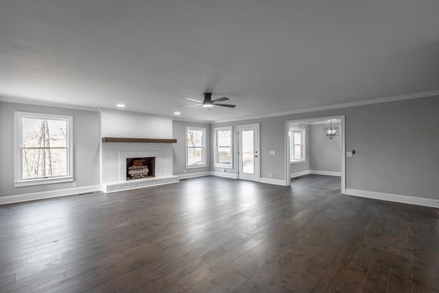 unfurnished living room with ceiling fan, a fireplace, plenty of natural light, and ornamental molding