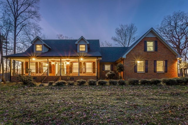 view of front facade featuring crawl space, covered porch, and brick siding